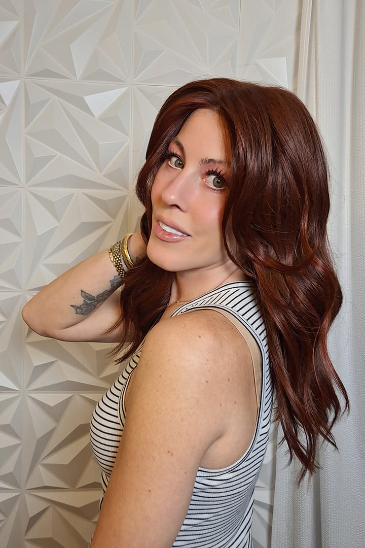 Woman with long wavy red wig (Decadent Diva by Raquel Welch in Deepest Ruby)