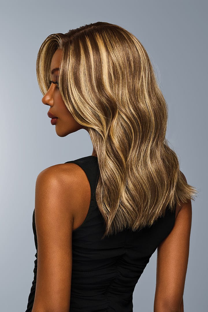 Woman is wearing Decadent Diva wig by Raquel Welch in color RL9/24SS | Left