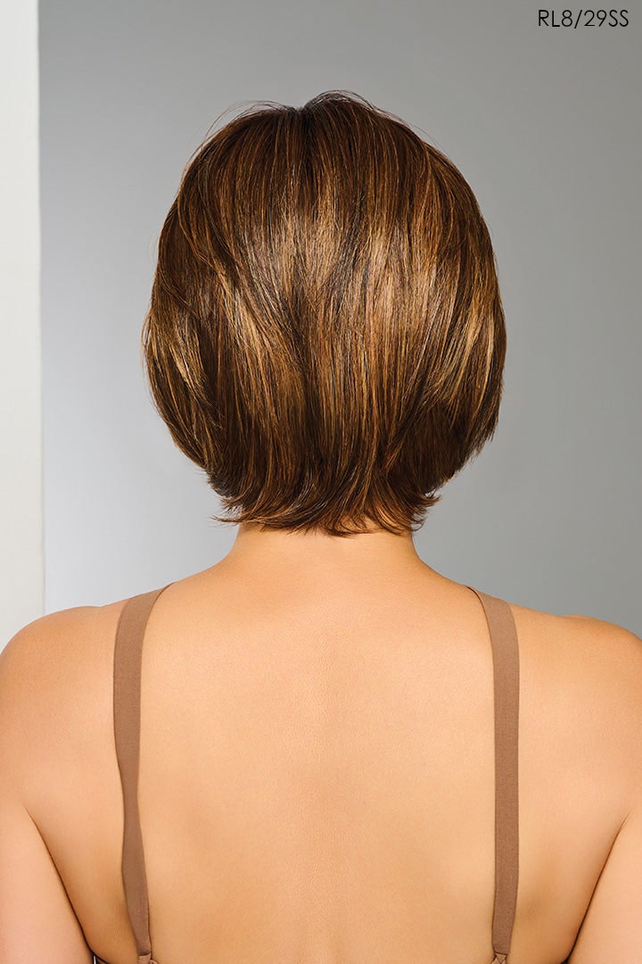 Back view of a woman with a short brown Raquel Welch Wig against a gray background