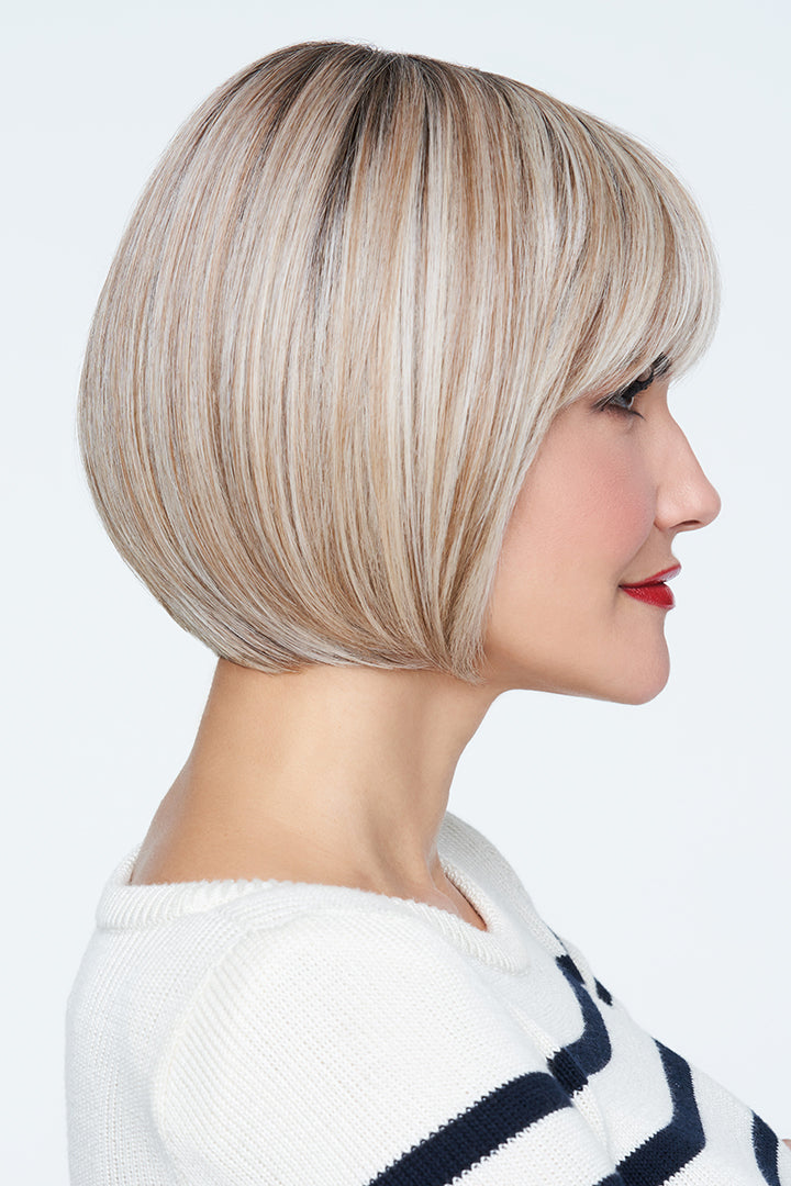Woman with a stylish blonde wig on a white background