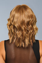 Back view of a shoulder-length synthetic wavy wig in a highlighted brown shade with a natural layered cut.