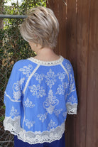 Woman wearing chin-length angled bob wig (Posh Premier by Raquel Welch in Shaded Biscuit)