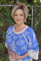 Woman wearing chin-length angled bob wig (Posh Premier by Raquel Welch in Shaded Biscuit)