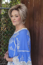 Woman wearing chin-length angled bob wig (Posh Premier by Raquel Welch in Shaded Biscuit)