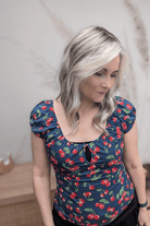 Woman with blonde curly wig (Jon Renau's Rachel Lite in color Catalina Blonde)