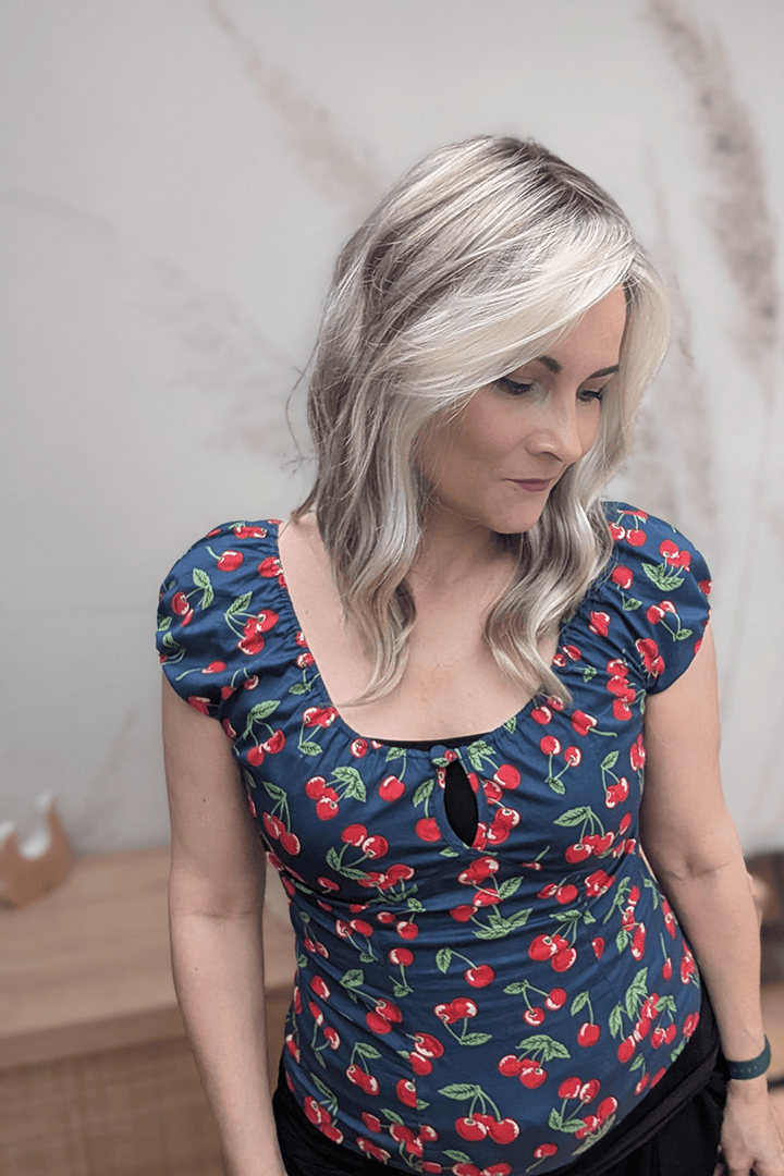 Woman with blonde curly wig (Jon Renau's Rachel Lite in color Catalina Blonde)