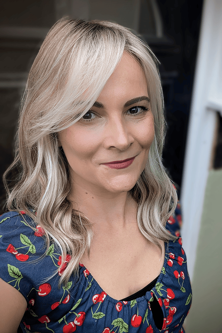 Woman with blonde curly wig (Jon Renau's Rachel Lite in color Catalina Blonde)