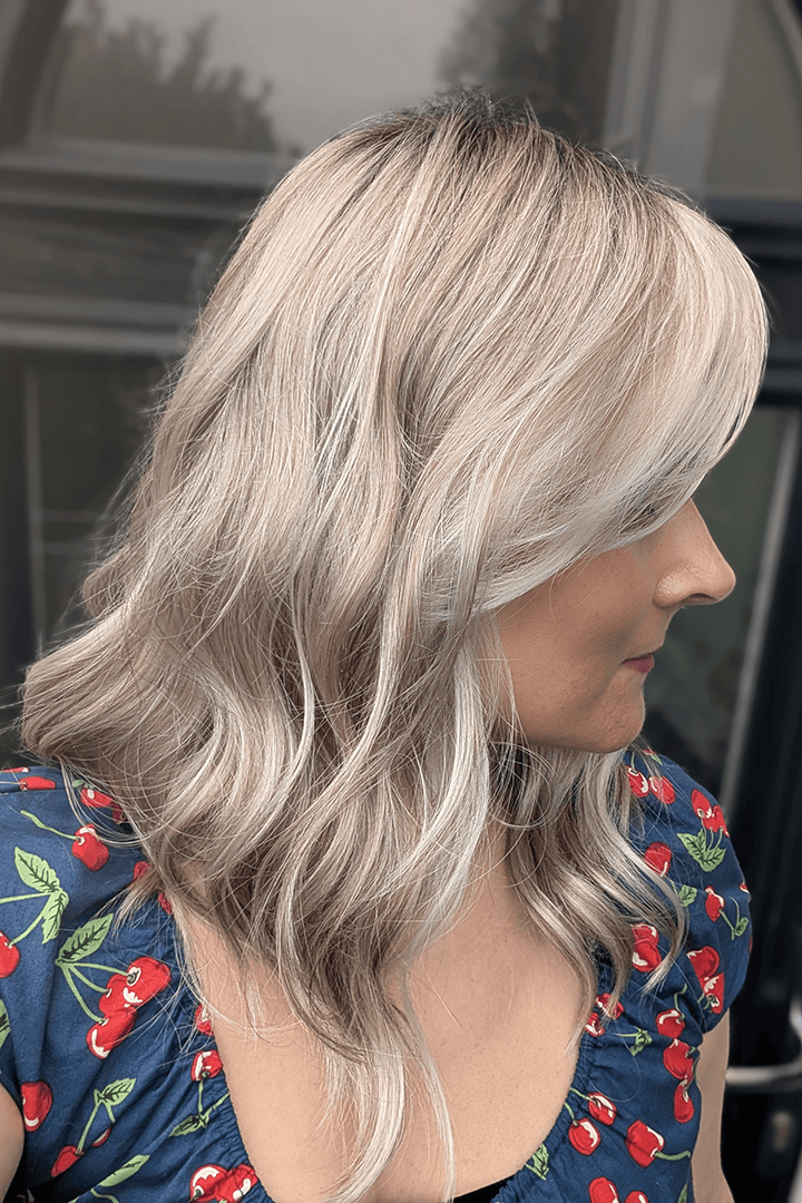 Woman with blonde curly wig (Jon Renau's Rachel Lite in color Catalina Blonde)