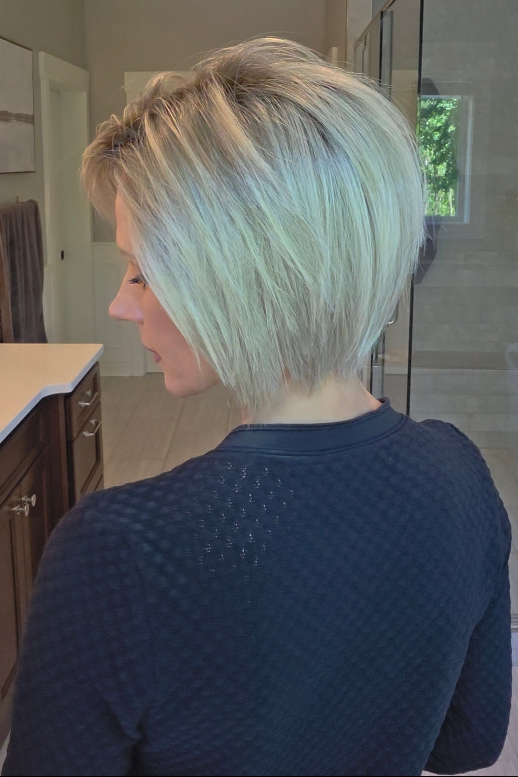 Woman wearing platinum blonde bob wig (Yvette by PUSH Hair in Bombshell Blonde). 