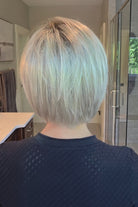 Woman wearing platinum blonde bob wig (Yvette by PUSH Hair in Bombshell Blonde). 