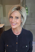 Woman wearing chin-length blonde bob wig (Classic Cool Petite by Raquel Welch in Shaded Iced Latte Macchiato)