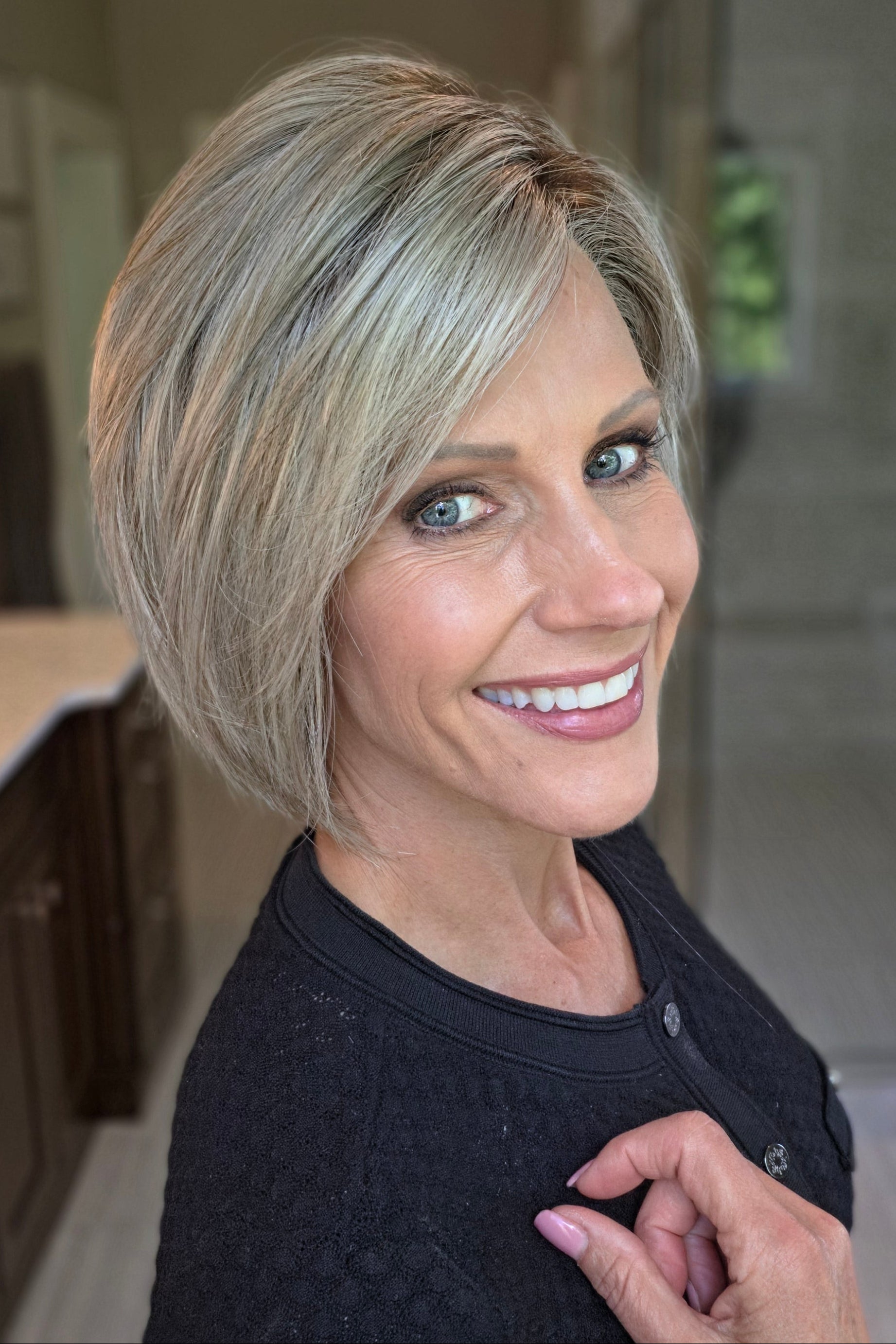 Woman wearing platinum blonde bob wig (Yvette by PUSH Hair in Bombshell Blonde). 
