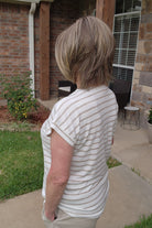 Woman wearing timeless brunette bob wig with golden highlights (Tailored Allure by Raquel Welch in SS Iced Cafe Latte)