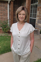 Woman wearing timeless brunette bob wig with golden highlights (Tailored Allure by Raquel Welch in SS Iced Cafe Latte)