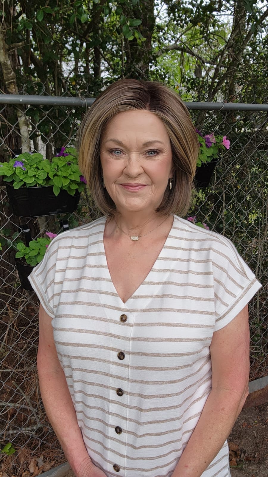 Woman wearing timeless brunette bob wig with golden highlights (Tailored Allure by Raquel Welch in SS Iced Cafe Latte)