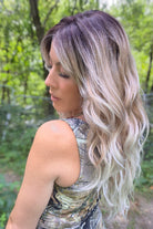 A woman with long blonde-highlighted hair wearing a camouflage-patterned tank top (Phillip by Rene of Paris in Melted Marshmallow R).