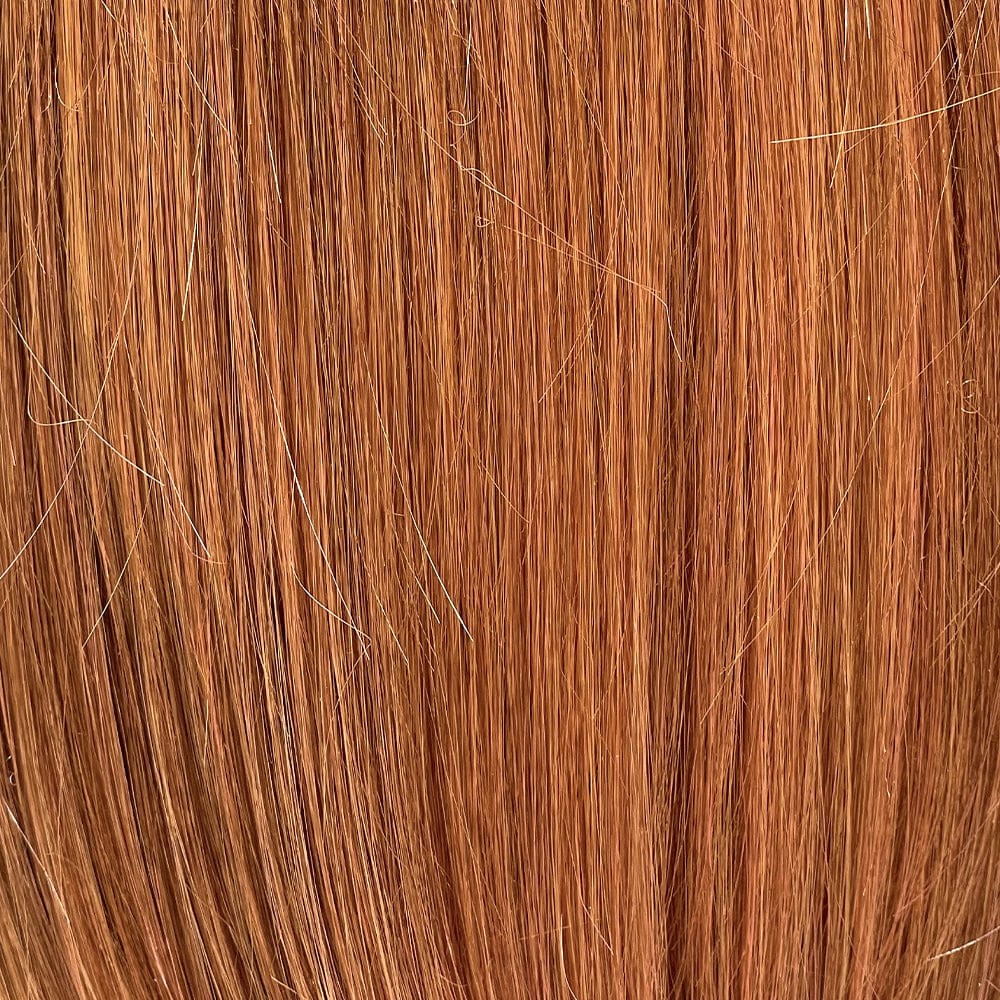 Close-up of Sienna Spice - Unrooted, light strawberry blonde/red with lowlights. 
