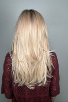Woman wearing a long layered rooted blonde wig (Sizzle by TressAllure in Sand and Sun Lighted)