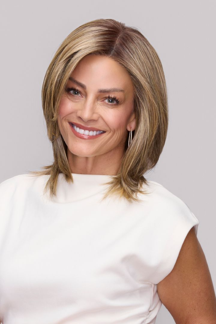 Mid-length layered blonde synthetic wig with a natural lace front on a smiling woman.