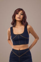 Woman with deep plum hair in denim top