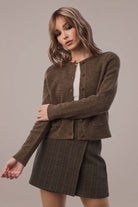 Woman in Smooth Wavez Snowy Umber cardigan & skirt