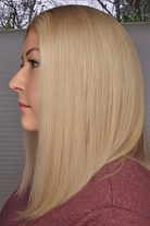 Woman with long blonde hair in a side profile view