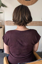 A woman with a short brown bob wig with subtle side-swept bangs (Stand Out Style by Gabor in color SS Hazelnut).