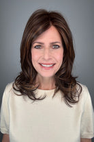 Woman wearing straight layered wig (Stephanie by WigPro in Pine Cone).