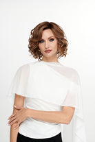 Woman wearing She's Like the Wind synthetic lace front wig by TressAllure in color 17/23/R8 with a white top and white background. Front view.