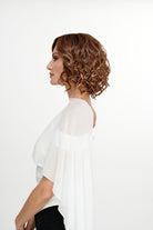 Woman wearing She's Like the Wind synthetic lace front wig by TressAllure in color 17/23/R8 with a white top and white background. Side view.