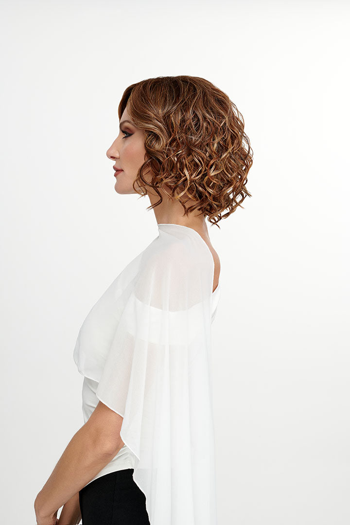 Woman wearing She's Like the Wind synthetic lace front wig by TressAllure in color 17/23/R8 with a white top and white background. Side view.