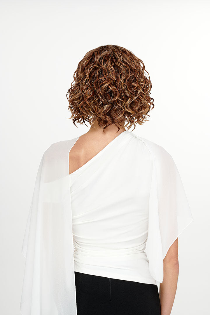 Woman wearing She's Like the Wind synthetic lace front wig by TressAllure in color 17/23/R8 with a white top and white background. Back view.