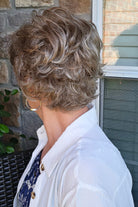 A woman with short textured blonde wig (Kenzie by Tony of Beverly in Silverstone).