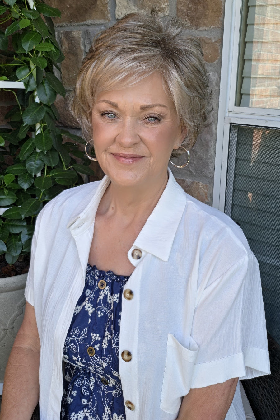 A woman with short textured blonde wig (Kenzie by Tony of Beverly in Silverstone).