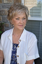 A woman with short textured blonde wig (Kenzie by Tony of Beverly in Silverstone).