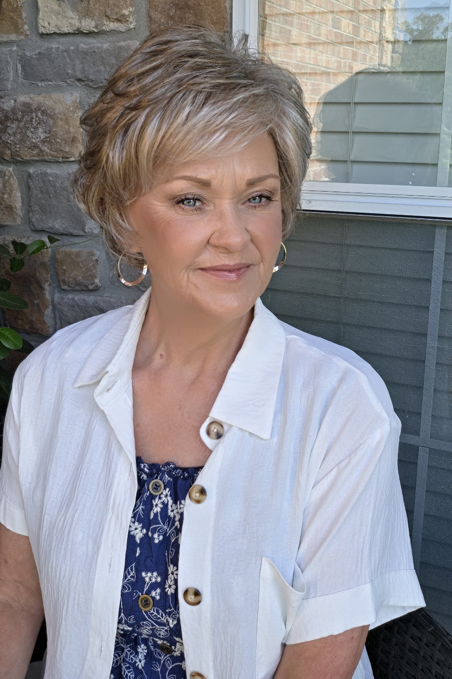 A woman with short textured blonde wig (Kenzie by Tony of Beverly in Silverstone).