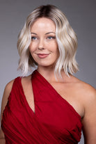 Tulip by Belle Tress chin-length blonde bob wig with soft waves, money piece highlights, and a center part.