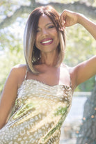 A woman smiling wearing Taylor synthetic wig by Noriko in color Mochaccino LR. Front view.