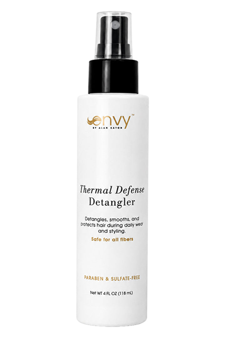 White 4 fl oz spray bottle of Envy Thermal Defense Detangler with a black pump cap and clear lid on a white background.