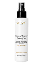 White 4 fl oz spray bottle of Envy Thermal Defense Detangler with a black pump cap and clear lid on a white background.