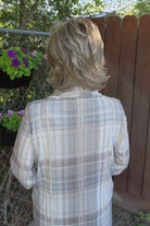 Woman wearing short shag wig (Razor Cut Shag by TressAllure in color Almond Cream).