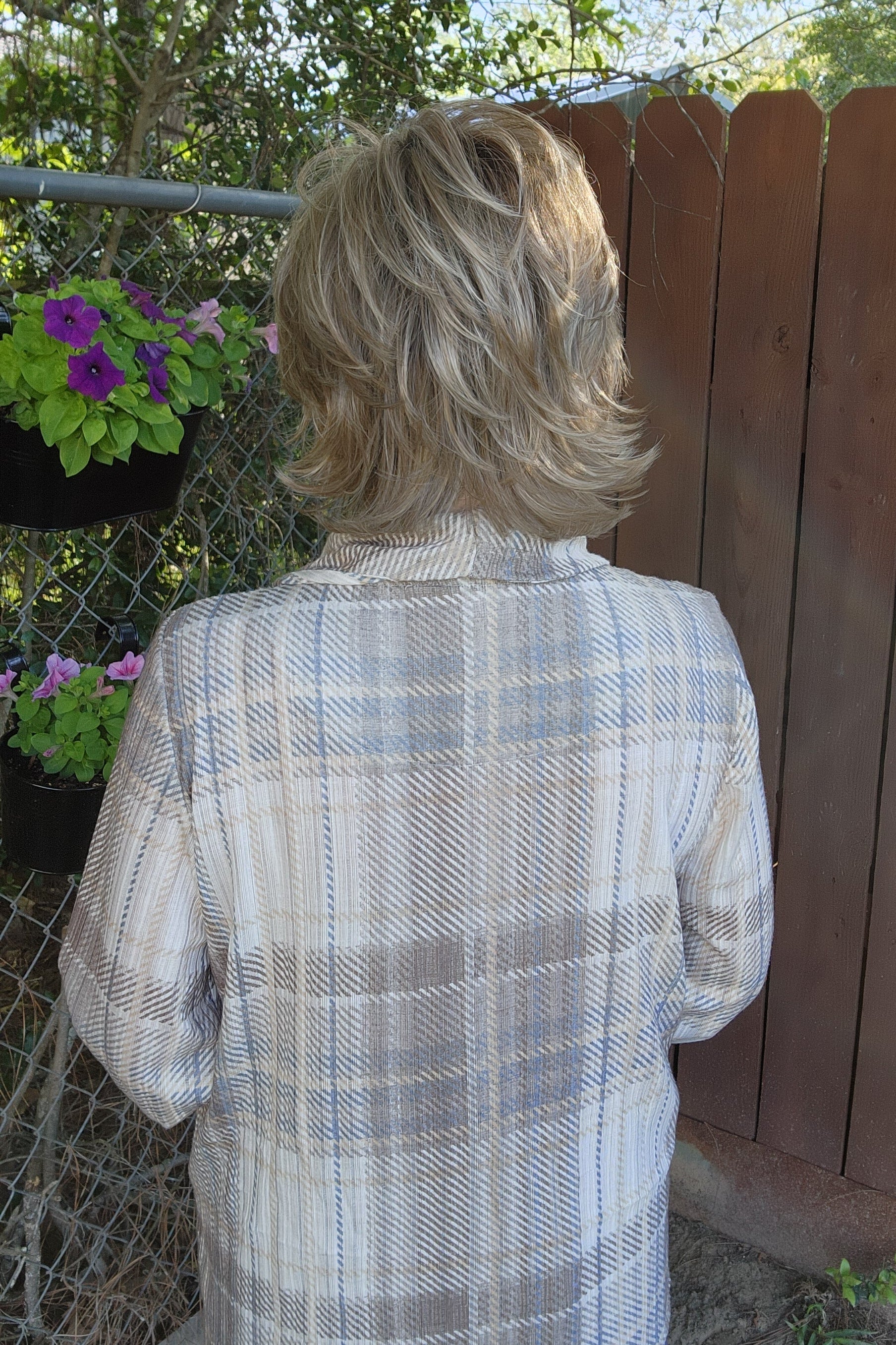 Woman wearing short shag wig (Razor Cut Shag by TressAllure in color Almond Cream).