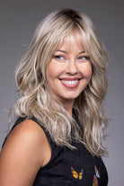 Vesper by Belle Tress synthetic layered shag wig in blonde with wispy bangs, lace front, and monofilament top.