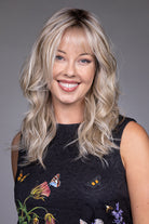 Vesper by Belle Tress synthetic shag wig with wispy bangs, layered blonde waves, and a natural lace front.
