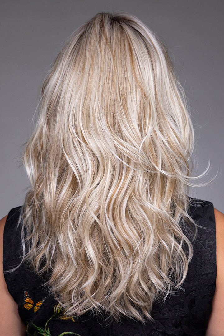Back view of Vesper by Belle Tress, a layered blonde shag synthetic wig with soft waves and airy volume.