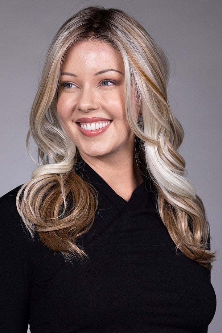 Wisteria by Belle Tress long wavy synthetic wig with blonde money piece highlights and a natural lace front.