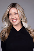 Wisteria by Belle Tress long wavy synthetic wig with blonde money piece highlights and a natural lace front.