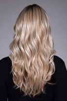 Back view of Wisteria by Belle Tress, a long synthetic wig with flowing blonde waves and soft, feathered layers.