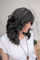 Woman wearing curly shouldar length (Belle Tress' Westwood in Coolest Dark Brown R) side