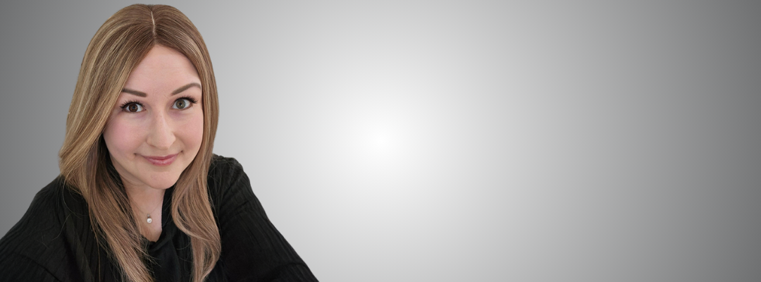 Woman with long brown hair wearing a black shirt.